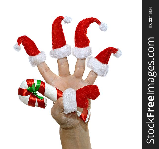 Hand with red furry finger hats and Christmas cane isolated. Hand with red furry finger hats and Christmas cane isolated
