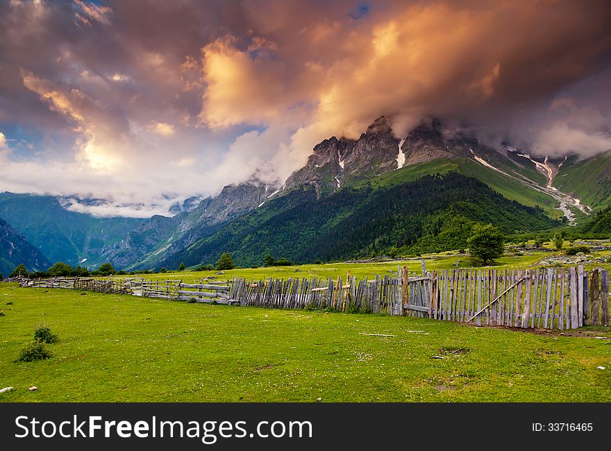 Majestic colorful sunset at the foot of Mt. Ushba. Upper Svaneti, Georgia, Europe. Caucasus mountains. Beauty world.