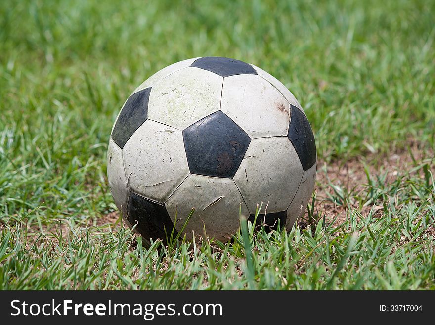 Old Soccer ball on grass