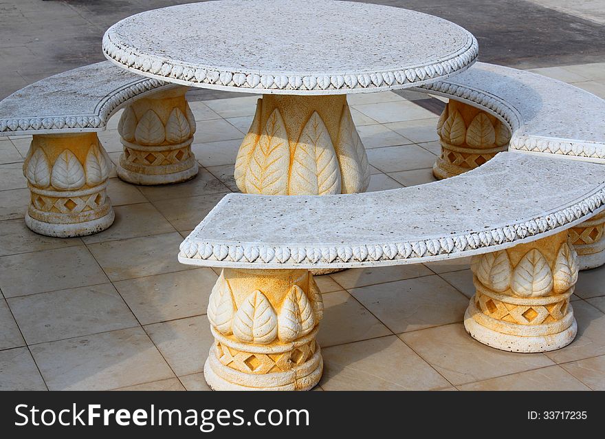 Ancient, carved stone table and benches decorative.