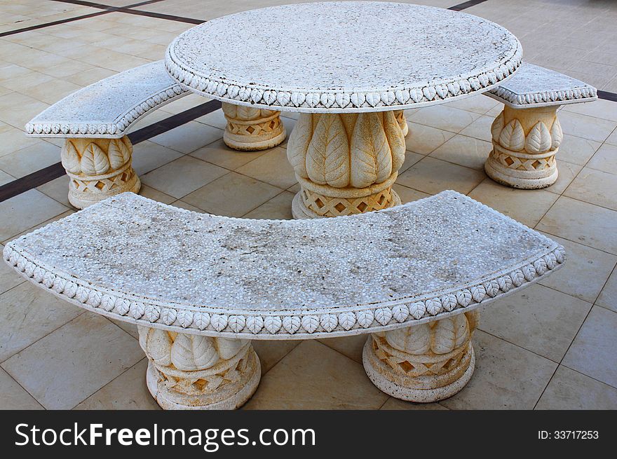 Ancient, carved stone table and benches decorative. Ancient, carved stone table and benches decorative.