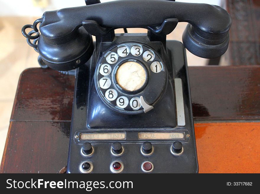 Antique rotary telephone on wooden desk. Antique rotary telephone on wooden desk.