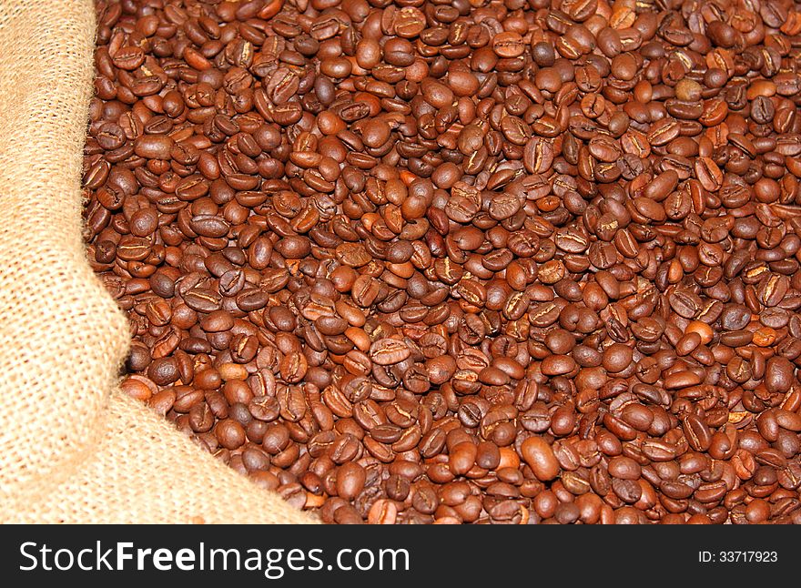 Roasted coffee beans in burlap sack