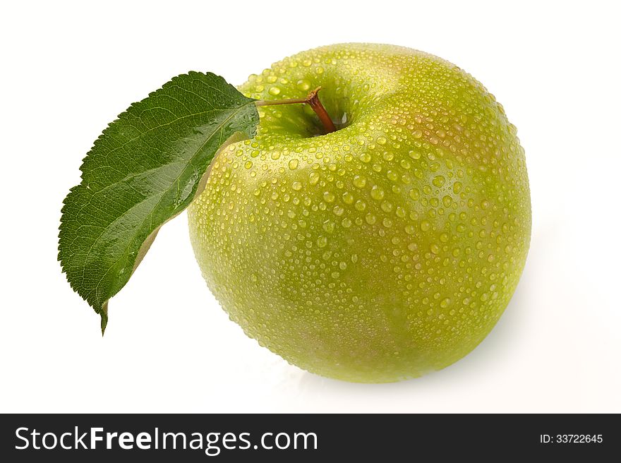 Green apple with water drops on a white background