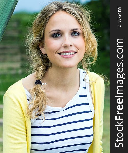 Portrait of young blonde girl at the park