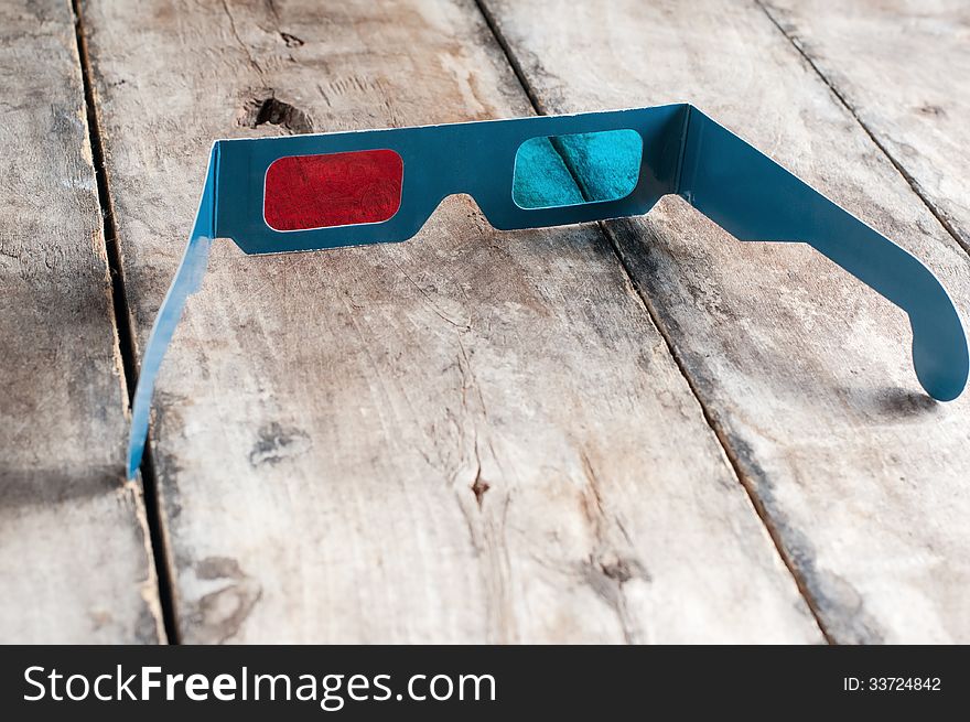 3d glasses on wooden table, close up photo