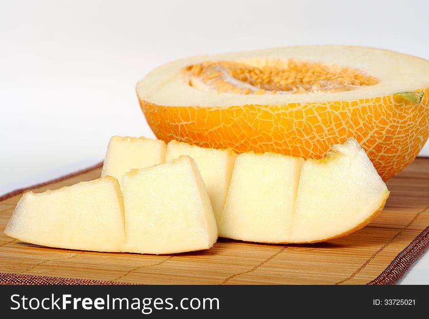 Melon slices next to a half melon close-up