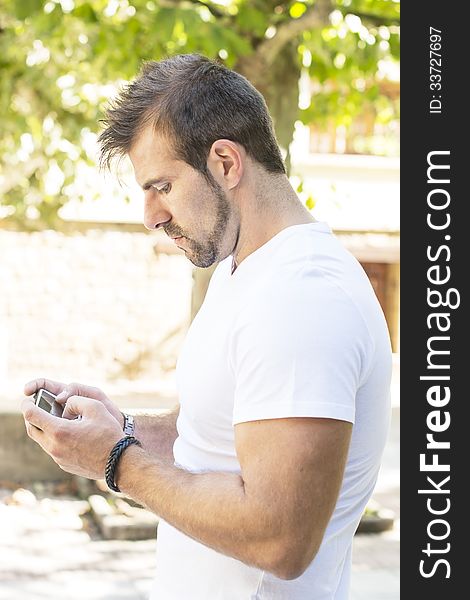 Portrait of man playing on phone.