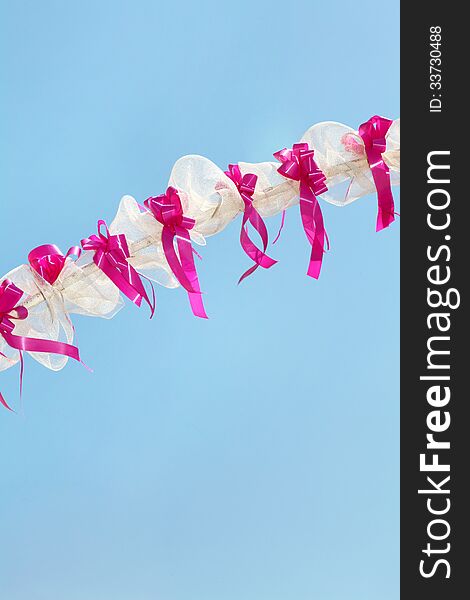 White and pink festive decoration with cloudless blue sky