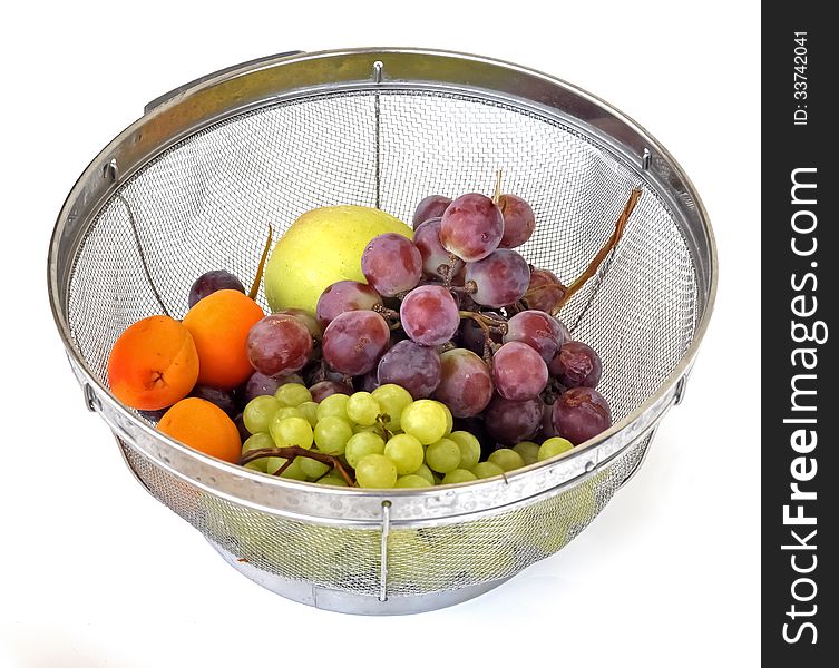 Summer fruits of grapes, apricots and apples in a strainer. Summer fruits of grapes, apricots and apples in a strainer