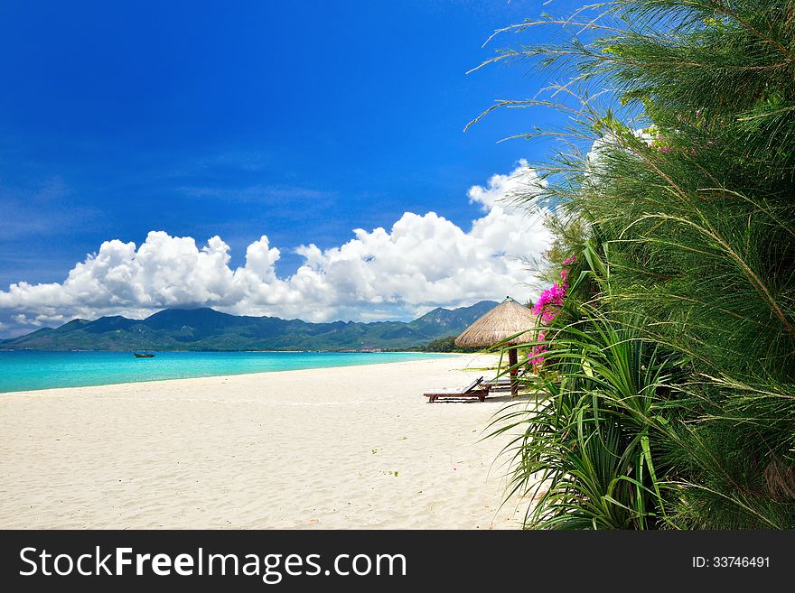 Tropical paradise beach with white sand on a background of mountains. Vietnam