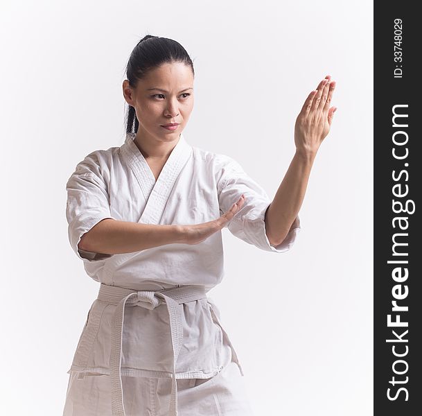 Woman in kimono show block in martial art on white. Woman in kimono show block in martial art on white