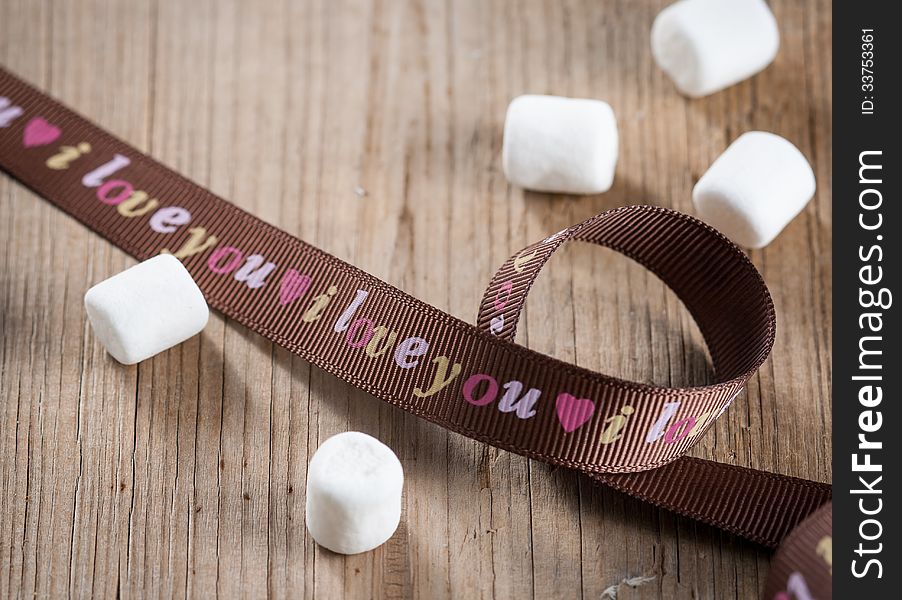 Sweet marshmallows and brown ribbon