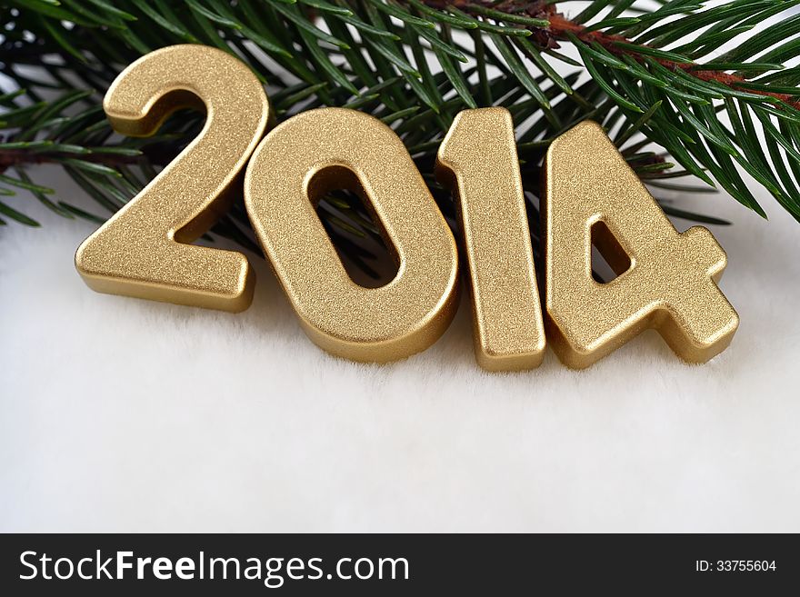 2014 year golden figures on a spruce branch
