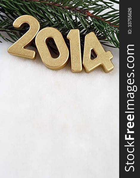 2014 year golden figures on a spruce branch