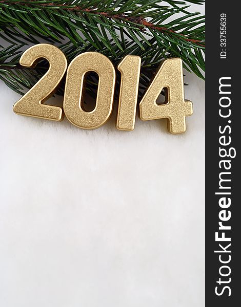 2014 year golden figures on a spruce branch