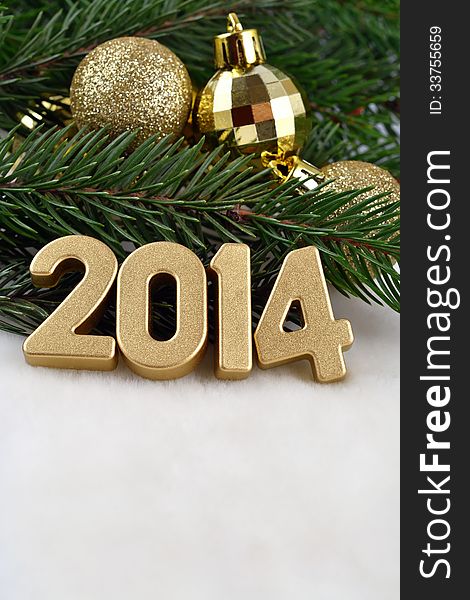 2014 year golden figures on a spruce branch