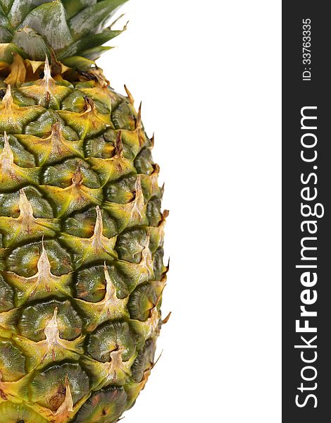 Pineapple is located half of a white background. Close up.
