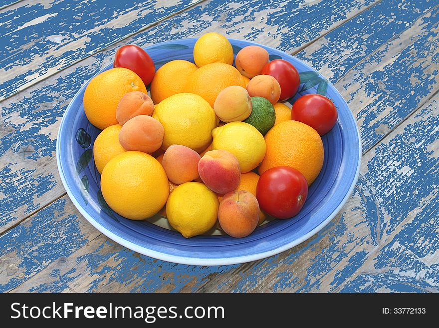 Bowl With Fresh Fruits At A Blue Colored Vintage Table