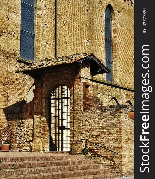 Part of the church in the background. San Gimignano, Tuscany. Part of the church in the background. San Gimignano, Tuscany.