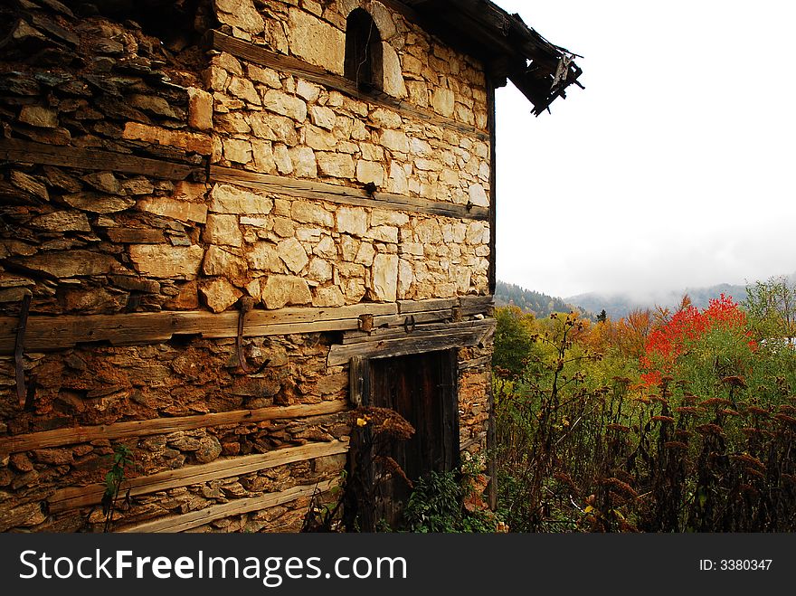 Old ruined house in autumn scenery