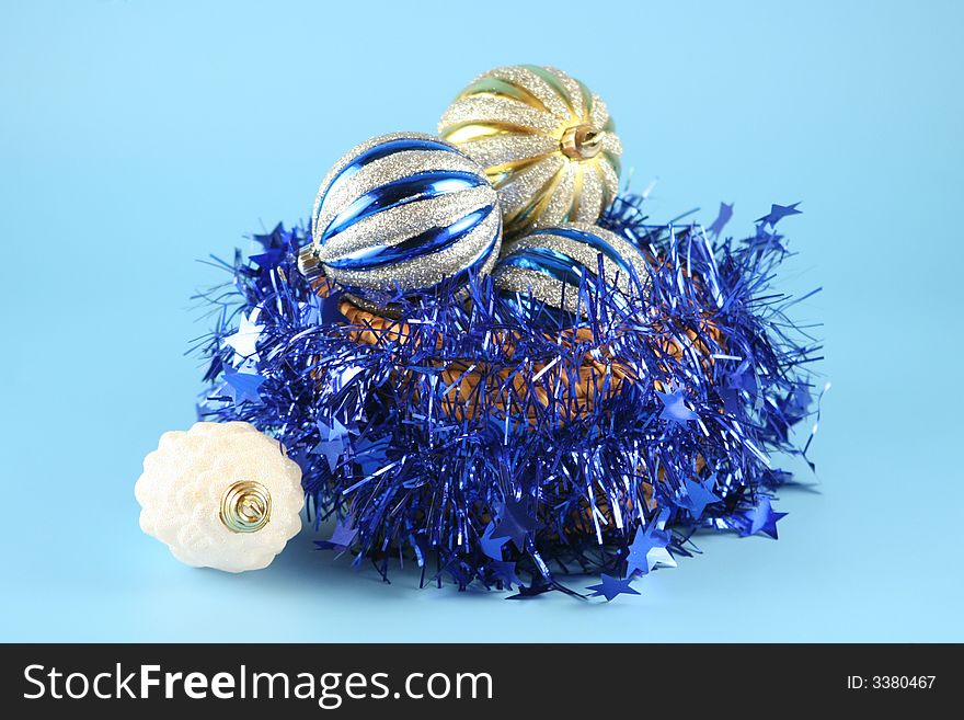 Christmas balls in a basket on a blue background.
