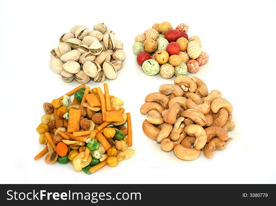 Different tasty nuts isolated on the white. Different tasty nuts isolated on the white.