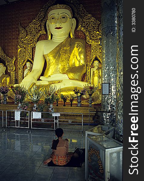 A woman praying the TheBuddha with Glasses. This Buddha have glasses because All The people around Myanmar who are wearing glasses come here to ask to the Buddha to take off forever glasses. In the Room there is a box with hundred of glasses of the people who have received this desire and took off the glasses forever. The Buddha' s glasses are been donated from a man who was one of the first to take off glasses after praying. A woman praying the TheBuddha with Glasses. This Buddha have glasses because All The people around Myanmar who are wearing glasses come here to ask to the Buddha to take off forever glasses. In the Room there is a box with hundred of glasses of the people who have received this desire and took off the glasses forever. The Buddha' s glasses are been donated from a man who was one of the first to take off glasses after praying