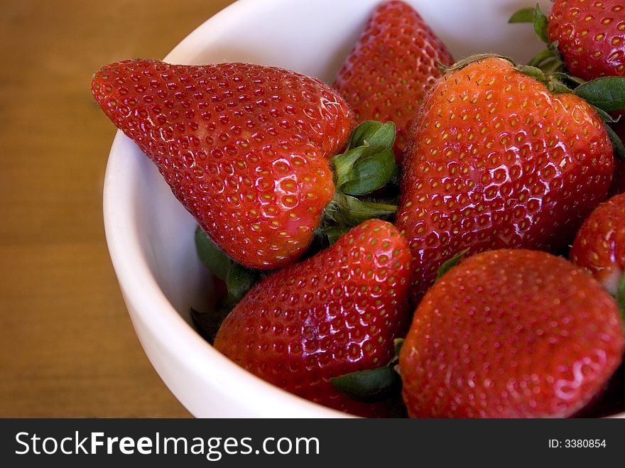 A large bowl of rich ripe red and juicy strawberries. A large bowl of rich ripe red and juicy strawberries