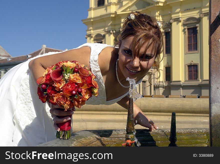 Bride drinking water after her wedding