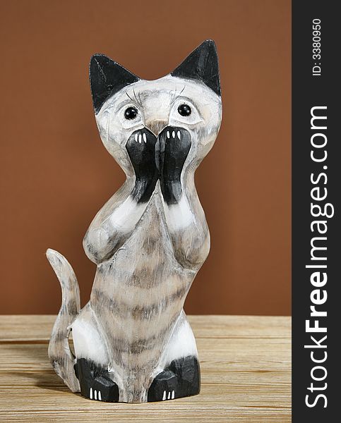 Home decoration trinket - wooden Siamese cat figurine. Home decoration trinket - wooden Siamese cat figurine.