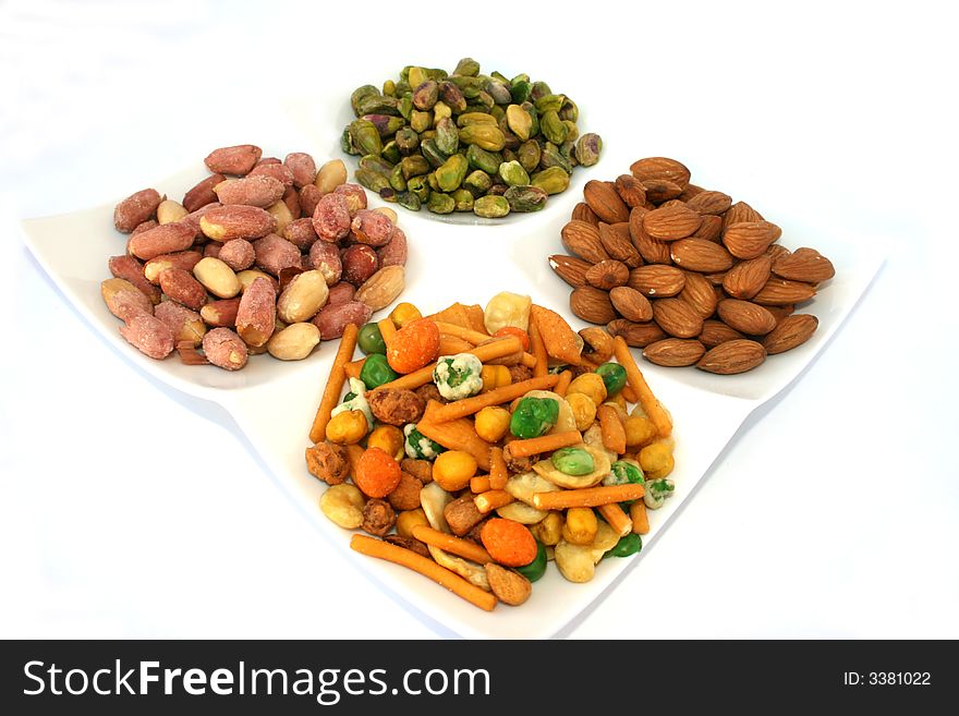 Different nuts on the dish isolated on the white. Different nuts on the dish isolated on the white.