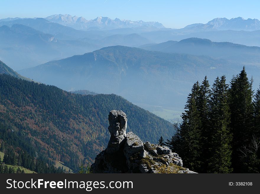 Rock on the Backgrounf of Mountains. Alpes, Bavaria, Germany . Sight from the Kampenwand Mountain ( Height 1665 m ).High Alpes in Austria is in the distance.October 2007 . Rock on the Backgrounf of Mountains. Alpes, Bavaria, Germany . Sight from the Kampenwand Mountain ( Height 1665 m ).High Alpes in Austria is in the distance.October 2007 .