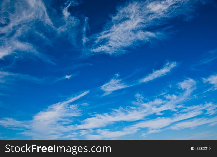 The sky and white fleecy clouds.