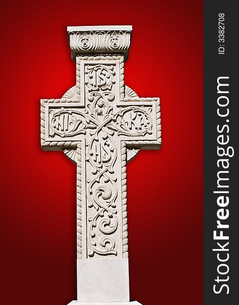 Old ancient stone cross on red background. Old ancient stone cross on red background