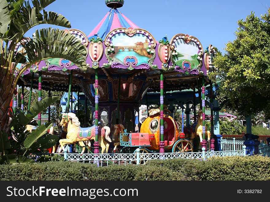 A merry-go-round hoarse and carriage ride at a carnival. A merry-go-round hoarse and carriage ride at a carnival