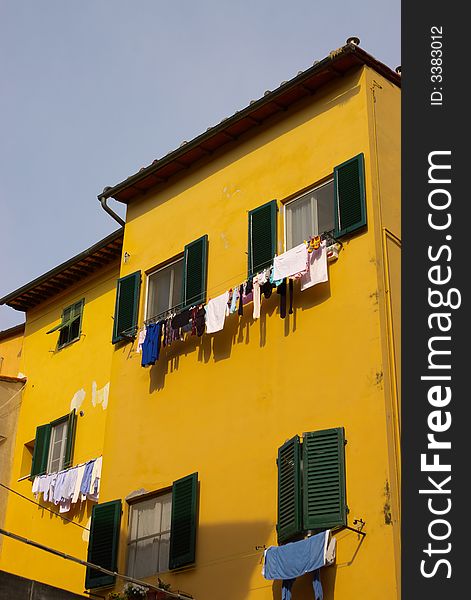 Italy town house with clothes drying outdoors in windows. Italy town house with clothes drying outdoors in windows.