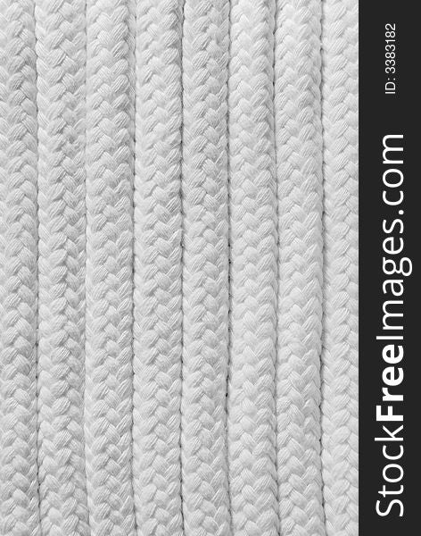 Rope background with some plaited white ropes.