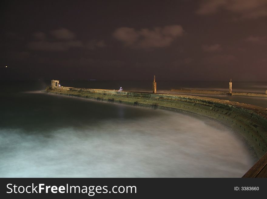 Lighthouse and jetty by night