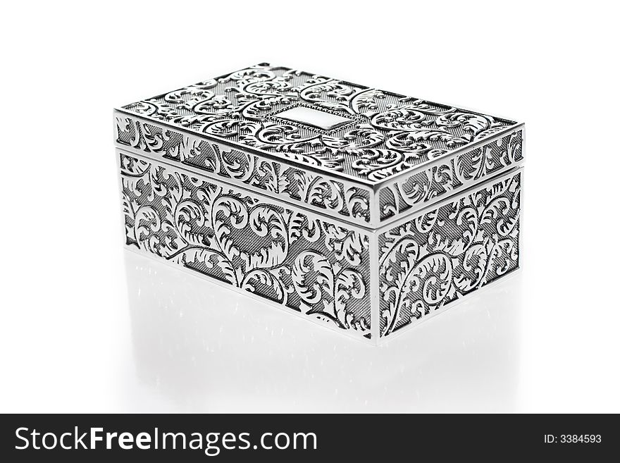 Old silver metallic retro casket over white background with reflection. Old silver metallic retro casket over white background with reflection