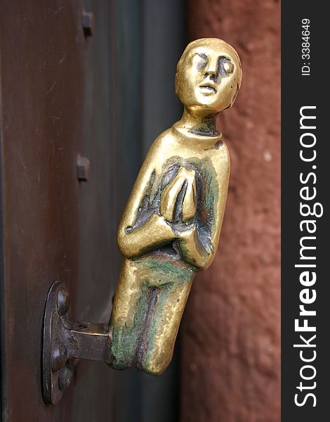 Old metal door knob of a church praying. Old metal door knob of a church praying