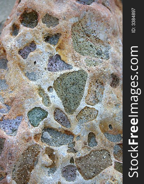 Beautiful texture of a washed beach rock with purple and green colors. Beautiful texture of a washed beach rock with purple and green colors
