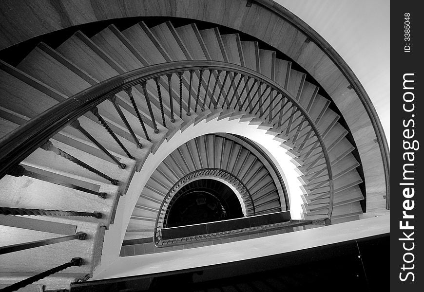 Black and white shot of a descending spiral staircase in a public building in Phoenix, Arizona. The design is late 1960's style