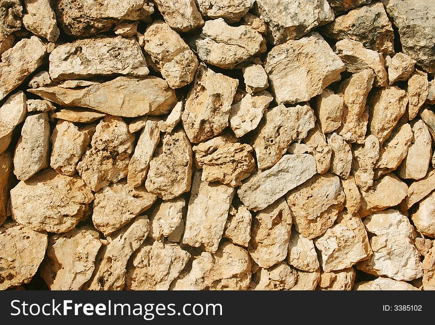 Background of a brown mediterranean stone wall