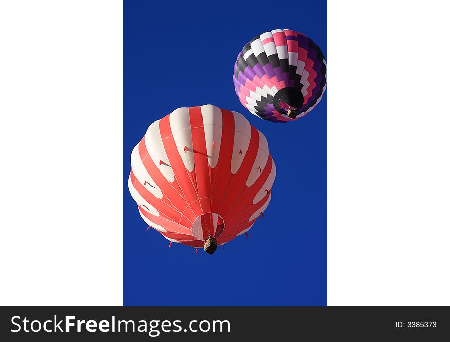 Two colorful hot air balloons taken from angle almost directly overhead. Two colorful hot air balloons taken from angle almost directly overhead