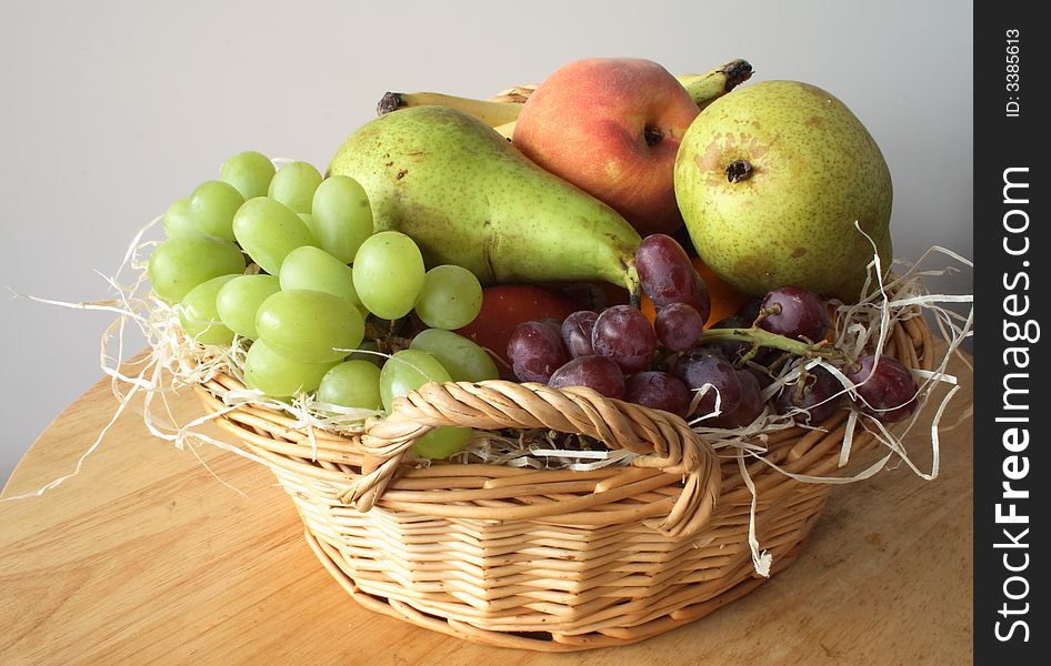 Gift basket of fresh fruit with wood shaving interior. Gift basket of fresh fruit with wood shaving interior