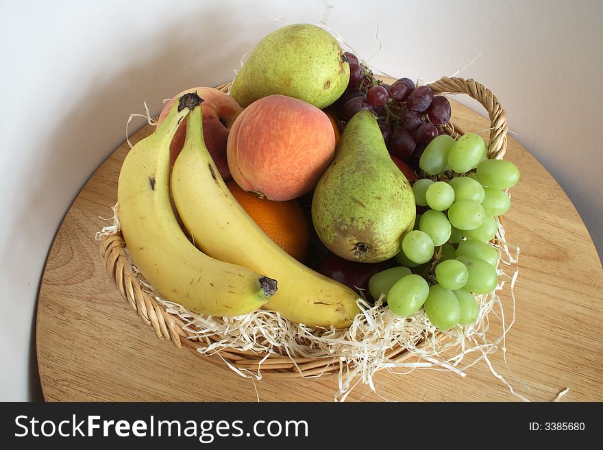 Gift basket of fresh fruit with wood shaving interior. Gift basket of fresh fruit with wood shaving interior