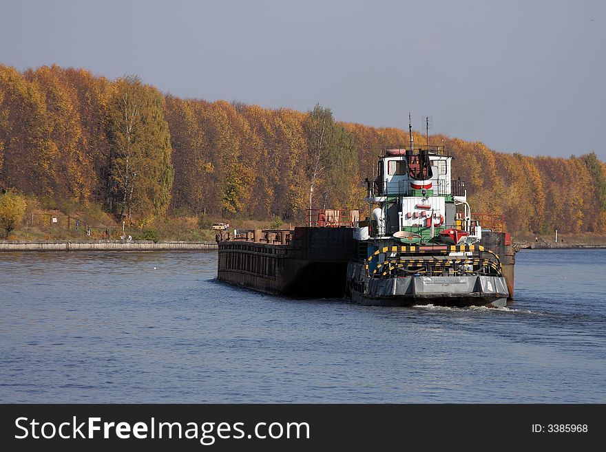 Barge pushed by towboat on the river.