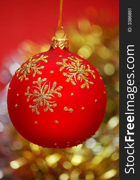Red christmas ball on a colorful blur background