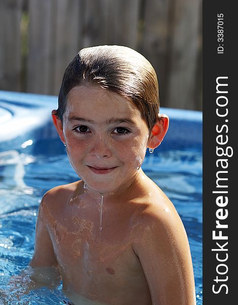 Cute young boy in pool smiling. Cute young boy in pool smiling